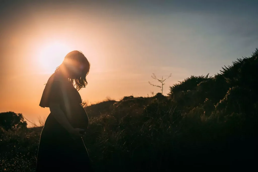 a pregnant woman at sunset, she chose life, not abortion