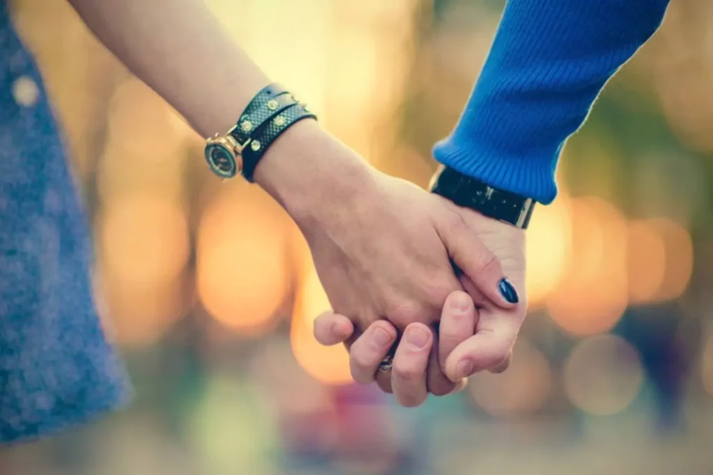 a couple holding hands, having scheduled time together