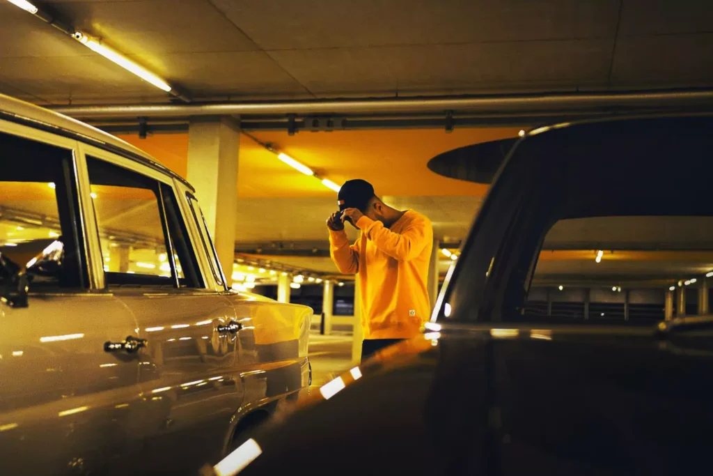a man looking down in a parking garage, a lesson in failure