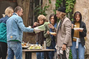 volunteers serving food to homeless people - thankfulness in action